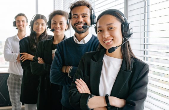 A group of smiling people in a call center.